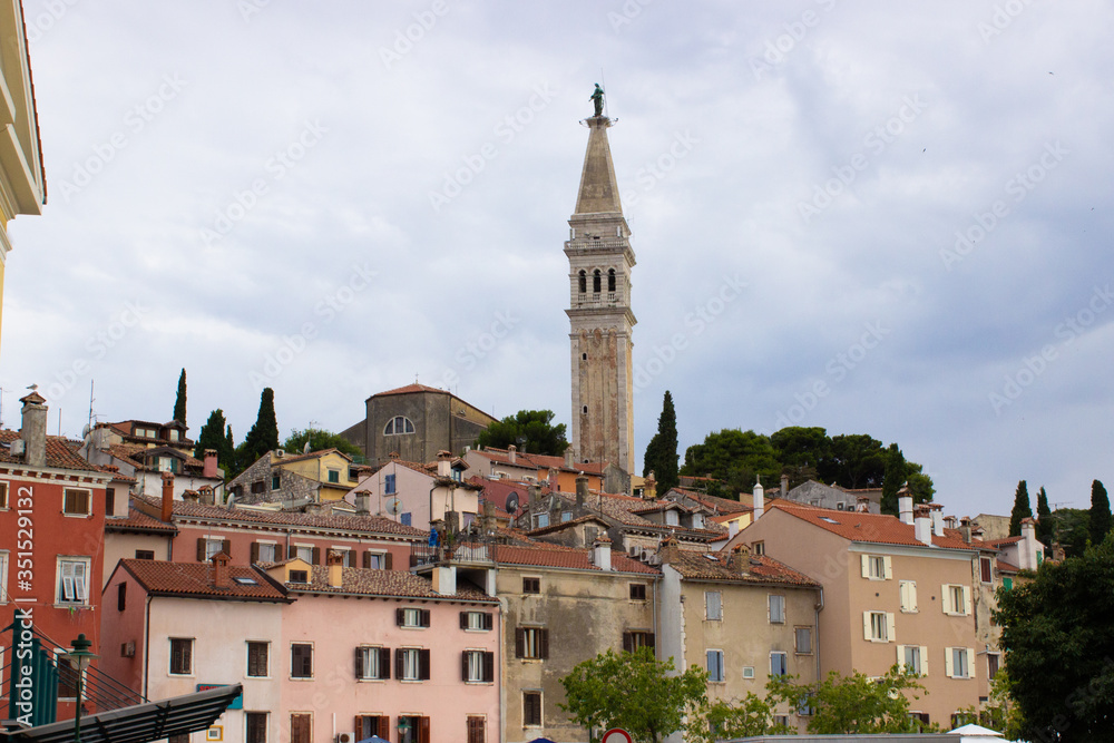 Old town of Rovinj, Croatia, with the facades of the typical croatian houses and the Church of St. Euphemia (also known as Basilica of St. Euphemia) on the top