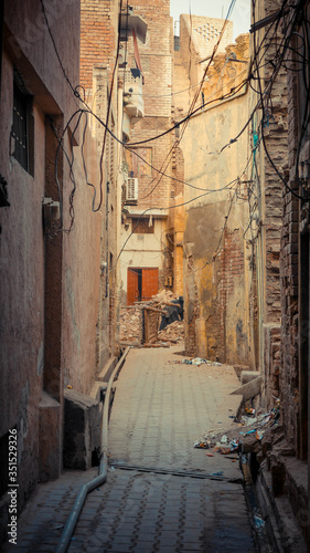 alleyway with wires and wall building both side