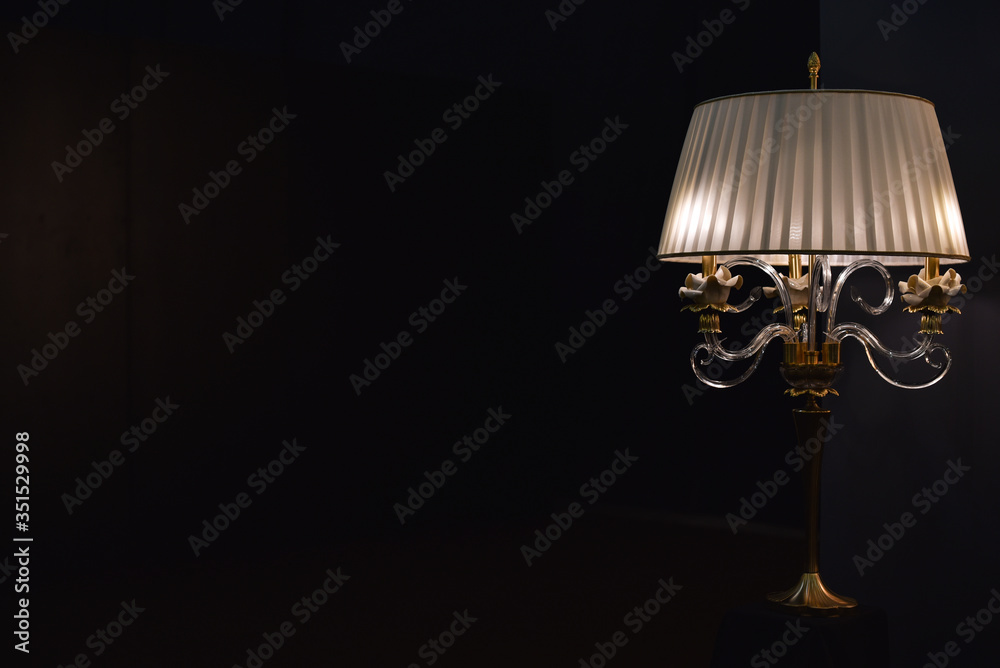 table lamp with bra in dark room