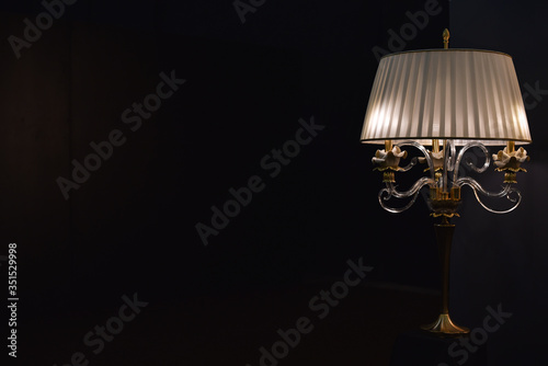 table lamp with bra in dark room