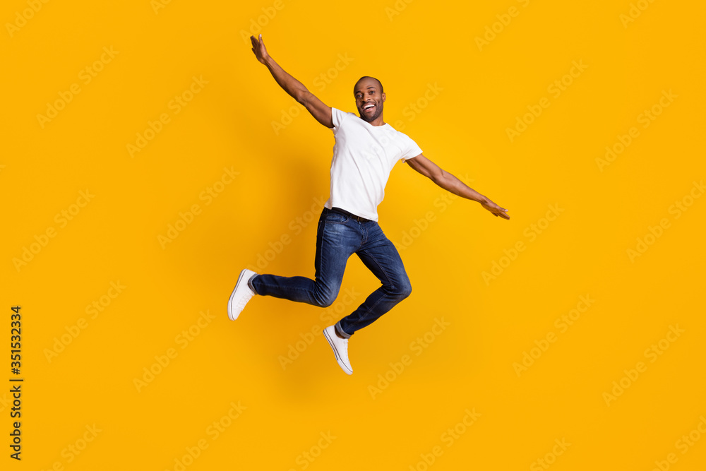 Full length body size view of his he nice attractive cheerful cherry guy jumping having fun weekend vacation free time isolated over bright vivid shine vibrant yellow color background