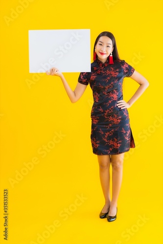 Portrait beautiful young asian woman wear chinese dress show white empty billboard