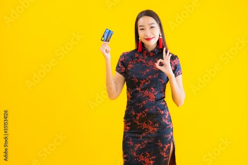 Portrait beautiful young asian woman wear chinese dress with credit card