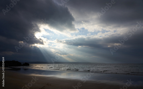 Rays of autumn sunlight breaking through the cloud at the beach of Big Sand near Gairloch in the Scottish Highlands, Scotland, UK.