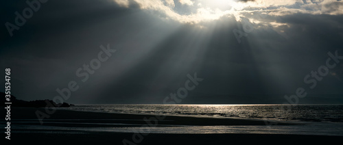 Rays of autumn sunlight breaking through the cloud onto the sea at Big Sand near Gairloch in the Scottish Highlands, Scotland, UK. © Duncan Andison