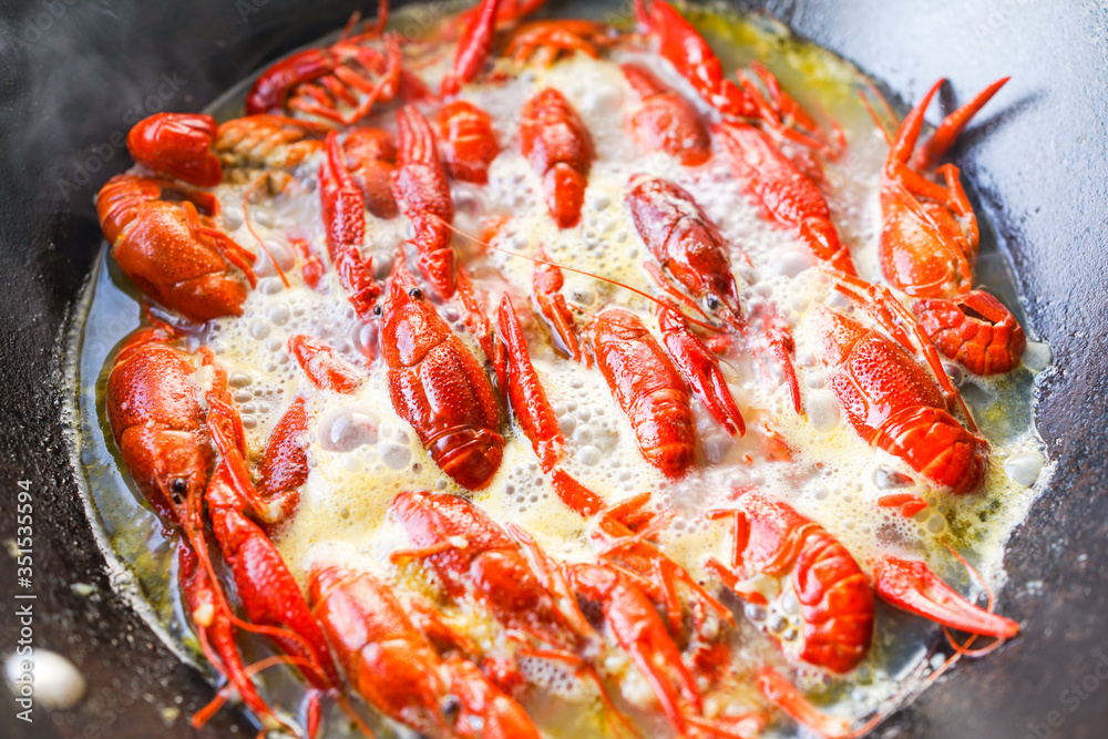 Chinese food with minced garlic and crawfish in the iron pot Chinese food with minced garlic and crawfish in the iron pot