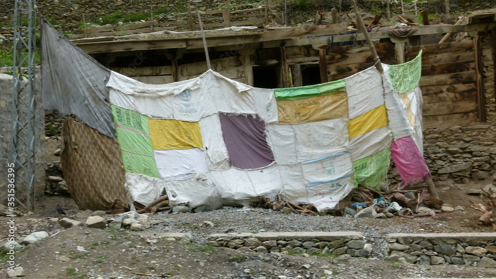 Long colorful fabric tied by the wooden pole Long colorful fabric tied by the wooden pole