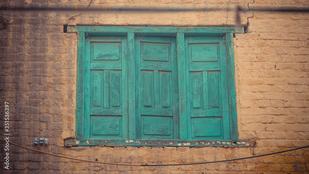 long green window on a white wall