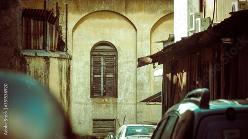 old brown window on the yellow wall