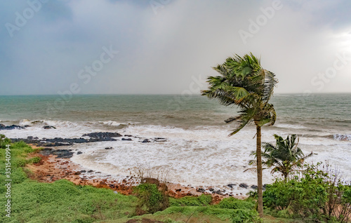 Fototapeta Naklejka Na Ścianę i Meble -  Climate change photo, taken during high speed cyclonic winds gushing through the coastal region, with heavy downpour taking place at horizon due to which it looks milky, and rain approaching coast.