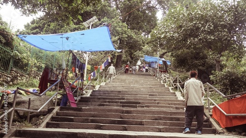 set of stairs with grey railings and blue cloth hanging