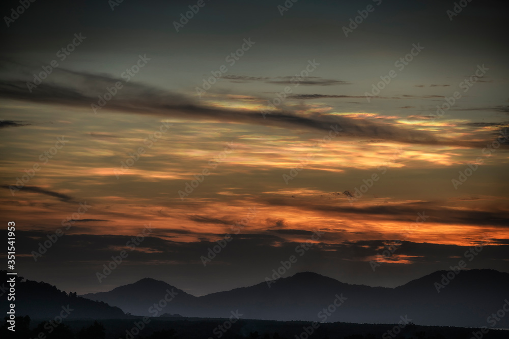 Nacreous cloud over mountain area in evening