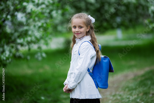 Yay, vacation! Happy girl in school uniform with school bag. The concept of pre-school education.