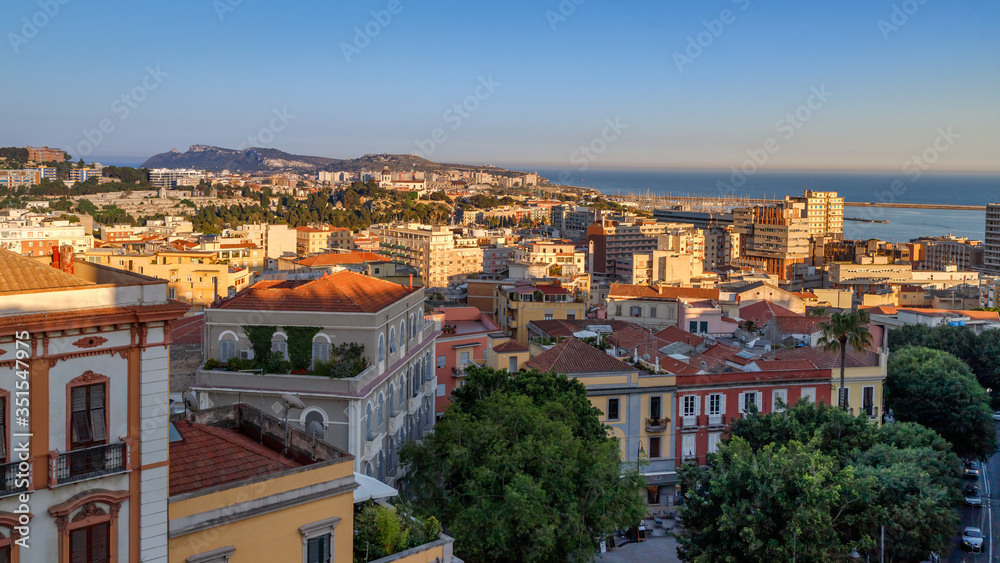 Cagliari, capital of Sardinia (Sardegna), Italy. Aerial panoramic view of the city. Cityscape at golden hour. Holidays in Sardinia.