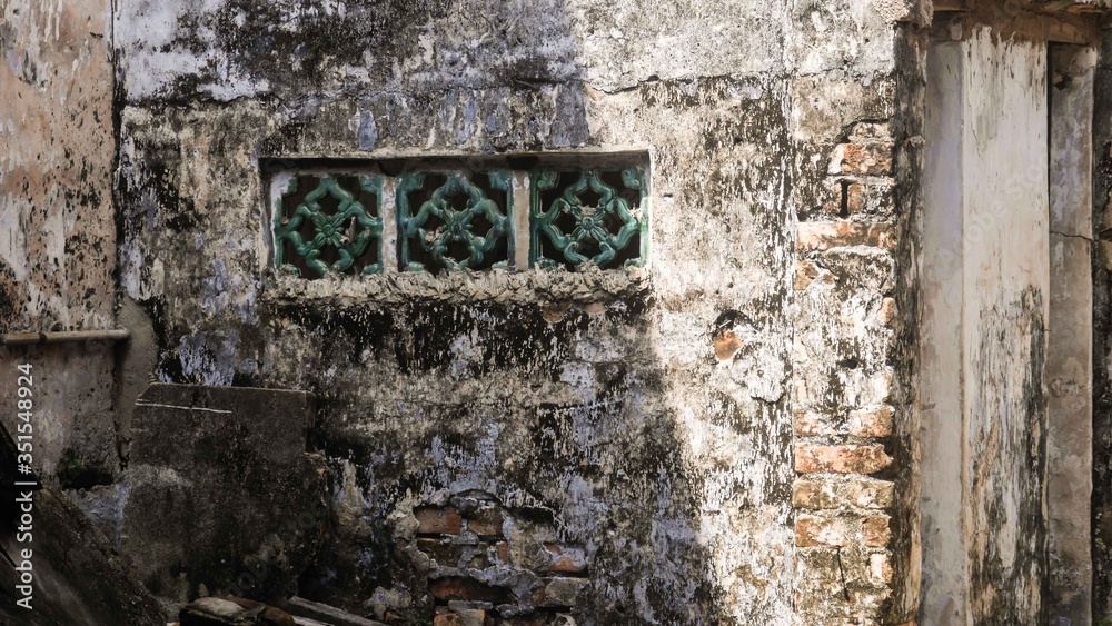 Worn down wall with green windows mounted Worn down wall with green windows mounted