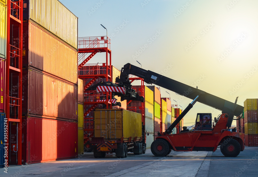 Reach stacker unload container from truck in container yards, Logistics operations.