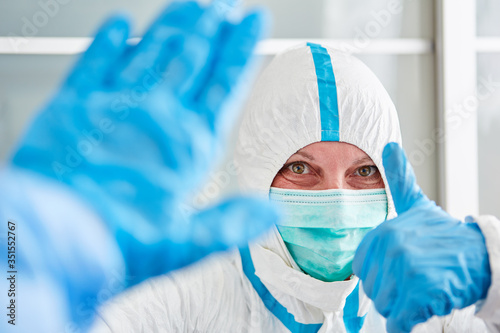 Nurses hold thumbs up in clinic during coronavirus pandemic