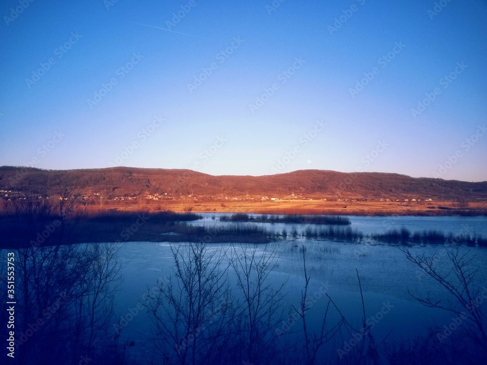 Fototapeta premium lake in fall season reflecting colorfully forest on the day