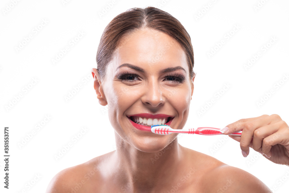 Woman with a beautiful smile preparing to brush her teeth Woman with a beautiful smile preparing to brush her teeth