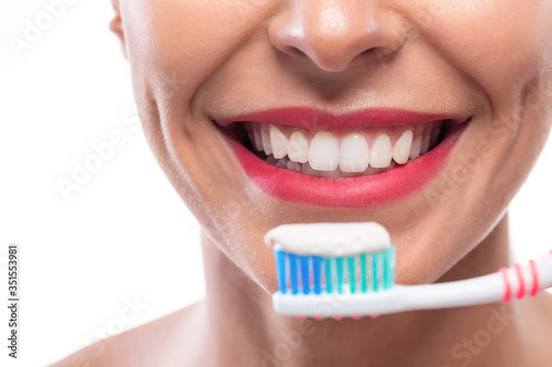 Close up of white teeth and a toothbrush
