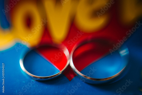 Wedding rings on a blue and red background with the yellow inscription Love   YEKATERINBURG  RUSSIA - 05 JULY 2019.