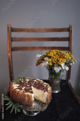 Cheesecake and wildflowers on the black chair