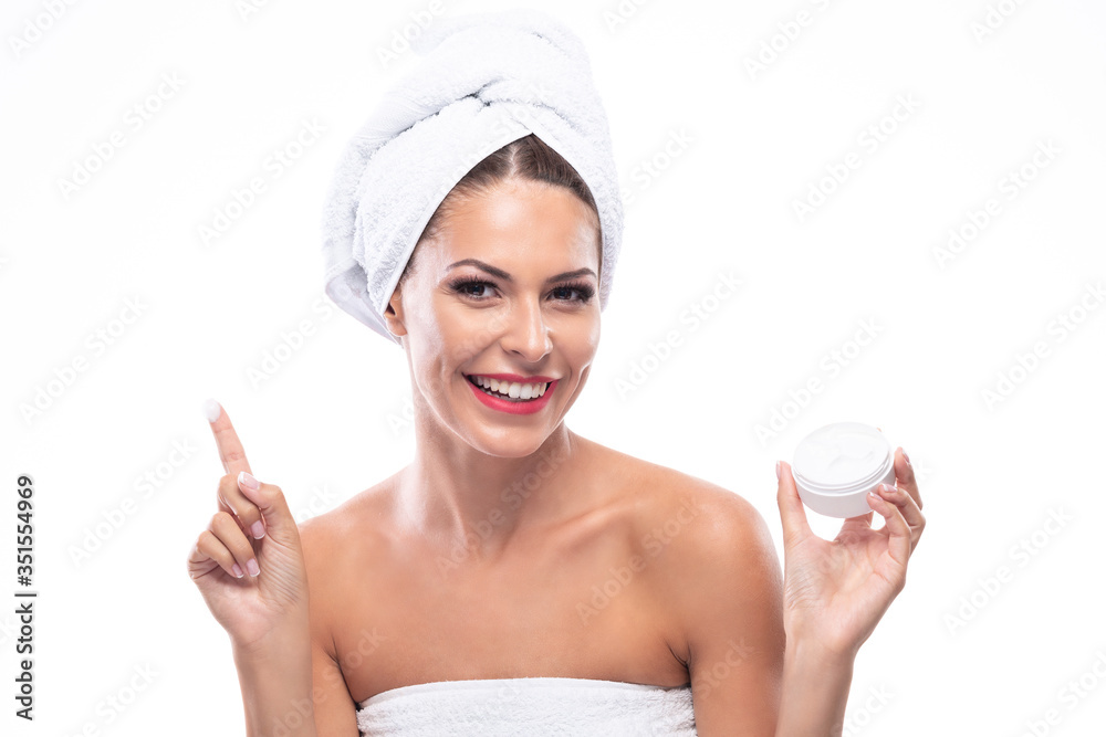 Portrait of a beautiful woman holding body cream in her hand