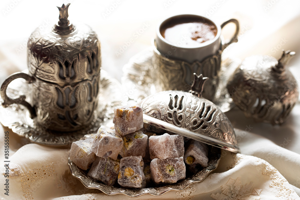 Turkish delight with coffee and traditional silver serving set. Feast of Ramadan.