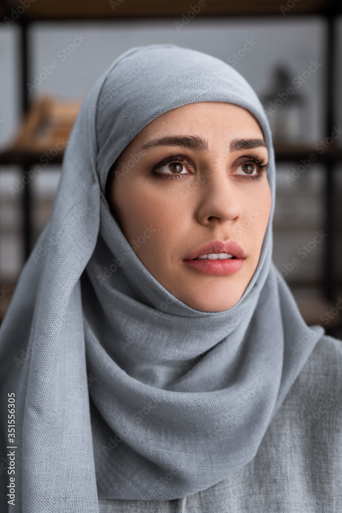 upset muslim woman in hijab looking up, domestic violence concept upset muslim woman in hijab looking up, domestic violence concept