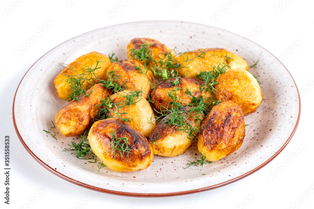 Fried fresh potatos and dill on a plate isolated on a white background