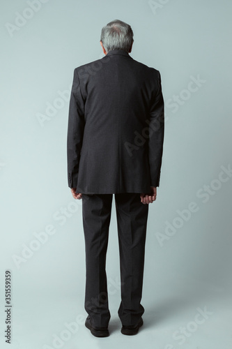 Rear view of a senior businessman in a suit photo