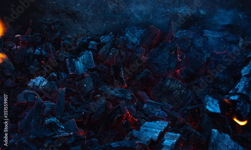 Burning coals in the dark, smoldering coal. Bright red sparks of fire. Background.	 photo