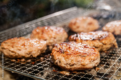 Fotografiet Close-up Of Pork Burger Patties On Barbecue Grill