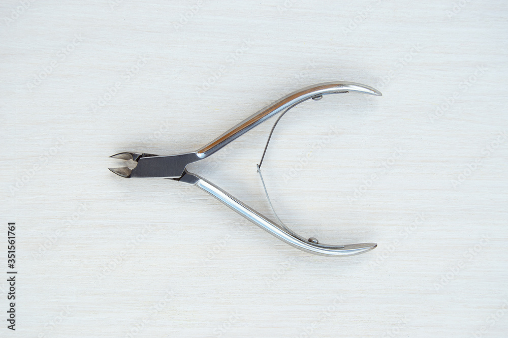 Cuticle clippers on a white background. Metal instruments for manicure and pedicure Cuticle clippers on a white background. Metal instruments for manicure and pedicure