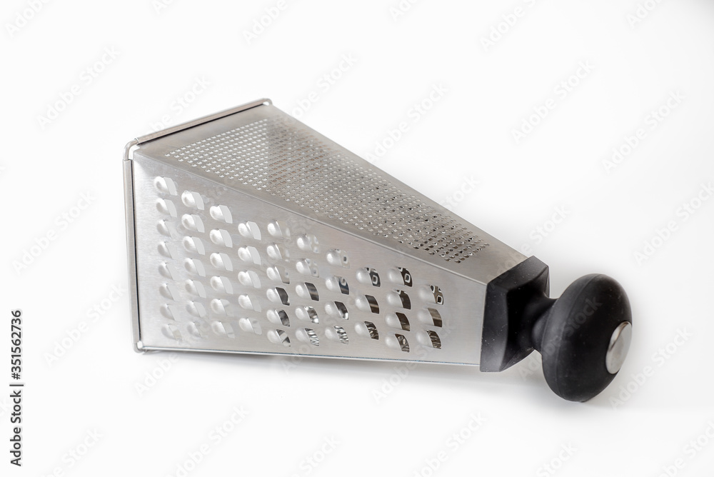 Square, cone-shaped grater for vegetables on a white background, isolated, lying Square, cone-shaped grater for vegetables on a white background, isolated, lying