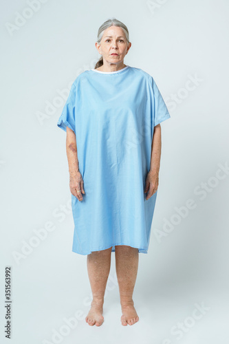 Quadro em tela Sad senior patient in a hospital gown
