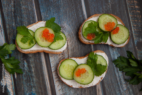 Sandwiches with greens on a wooden background