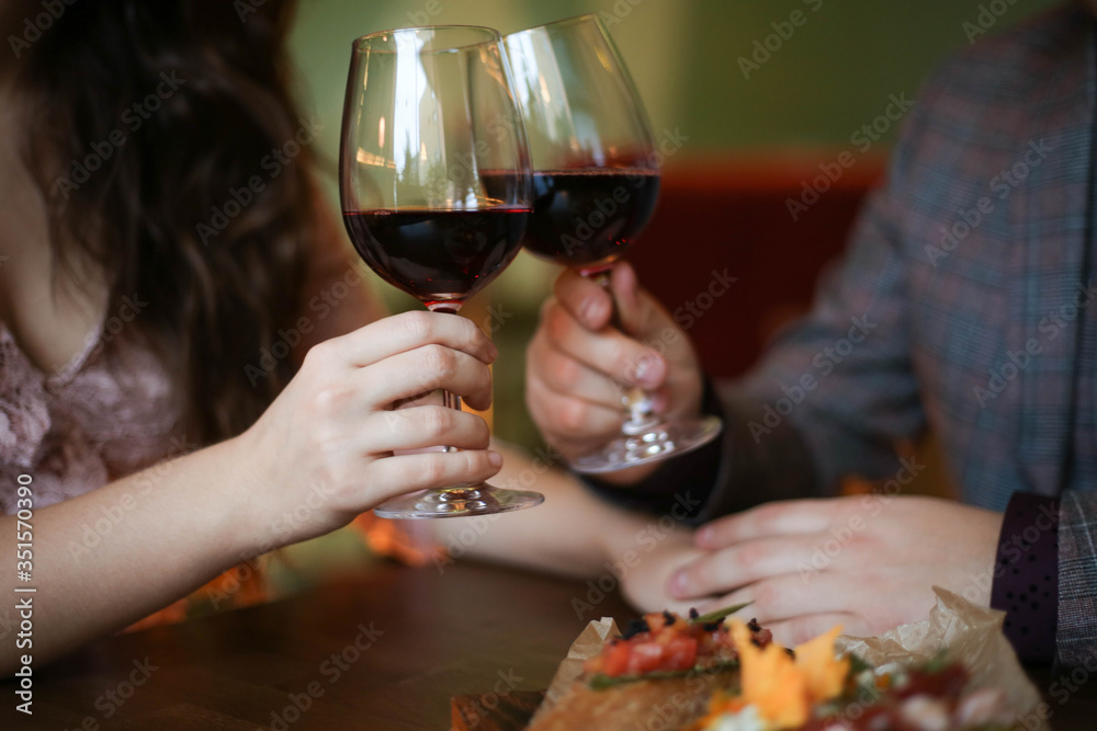 man and woman drinking wine