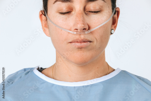 Sick female patient with a nasal cannula
