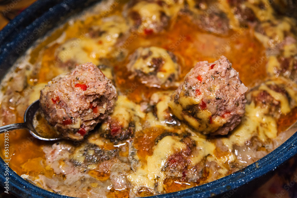 Homemade baked meatballs with vegetables and rice cooked in tomatoe and sour cream sauce.