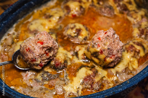 Homemade baked  meatballs with vegetables and rice cooked in tomatoe and sour cream sauce.