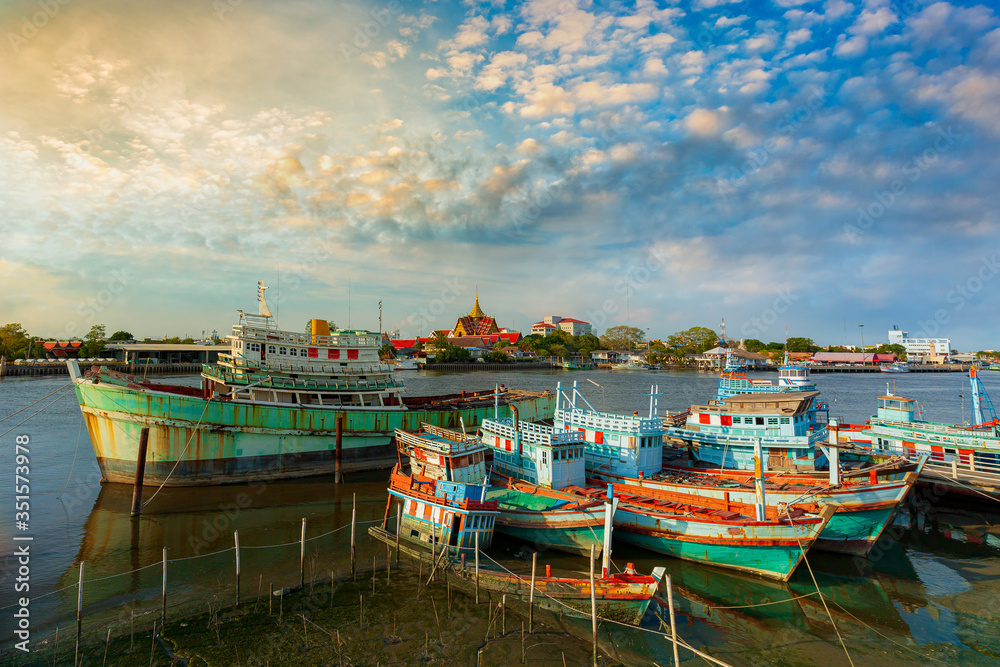 A group of fishing boats and incredible sky in the evening in Thailand