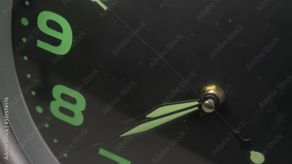 close up on reverse image of wall clock - clock hands turning