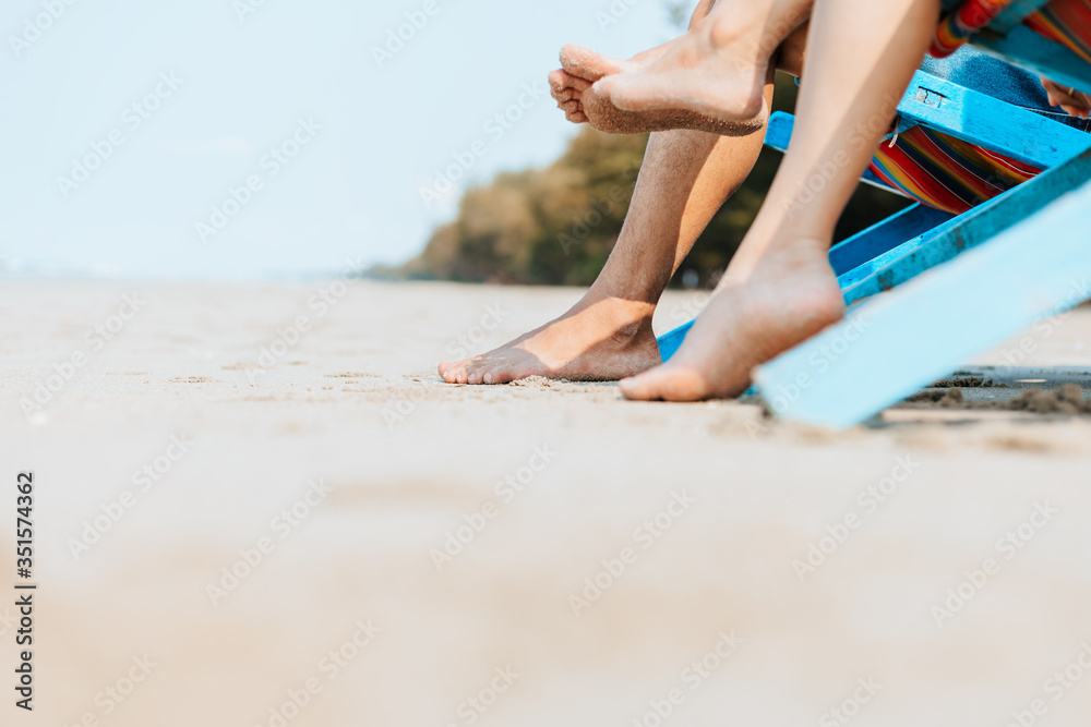 Couple sitting on the deck chairs at the beach. honymoon, Love, travel or vacation concept. Couple sitting on the deck chairs at the beach. honymoon, Love, travel or vacation concept.