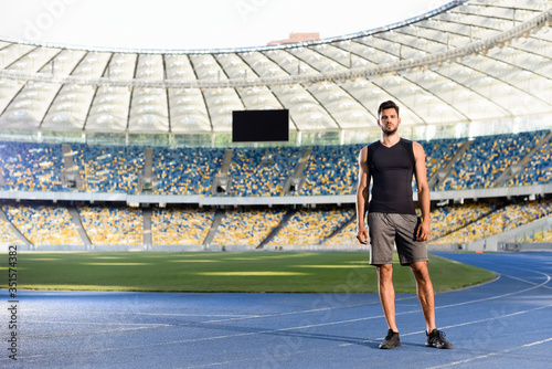 handsome young sportsman on running track at stadium © LIGHTFIELD STUDIOS