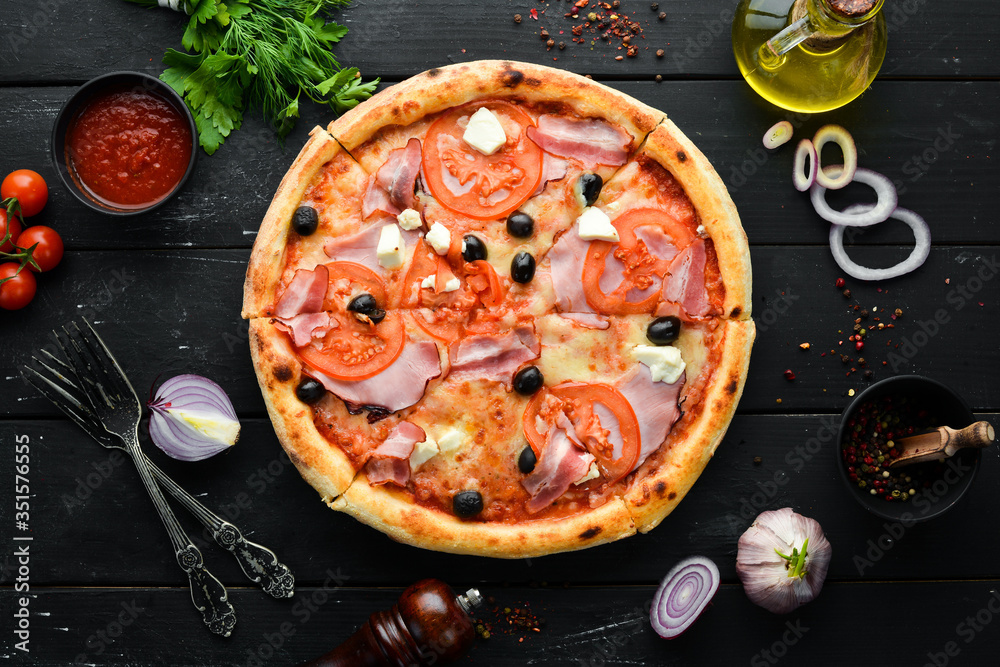 Italian pizza with tomatoes, bacon and olives. Top view. Free space for your text.
