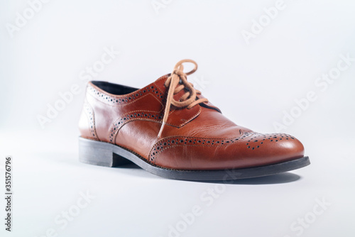 Classic brown leather one shoes on white background. Concept
