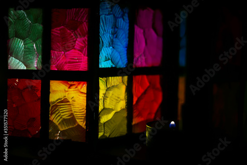 stained glass multi-colored glass of a beautiful lantern with a burning candle