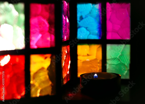 stained glass multi-colored glass of a beautiful lantern with a burning candle