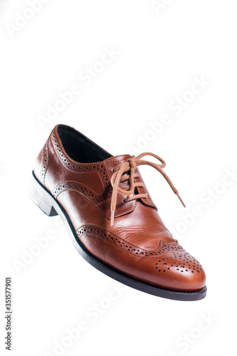Brown leather shoes in perspective and isolated on white